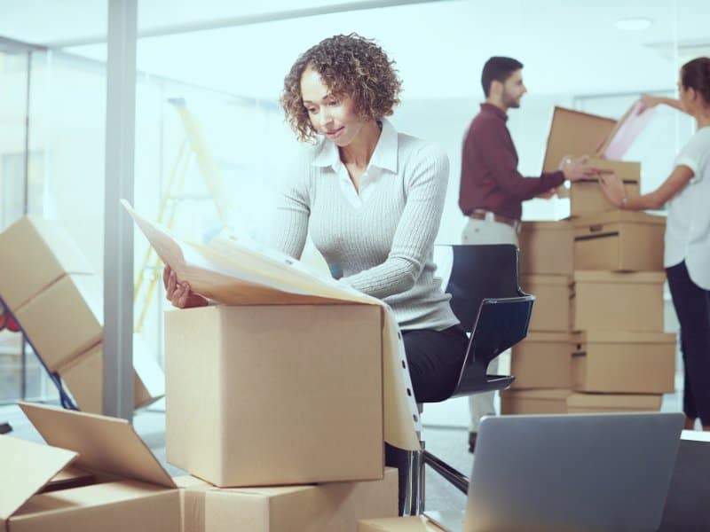 woman helping pack up a Long Island office for moving.