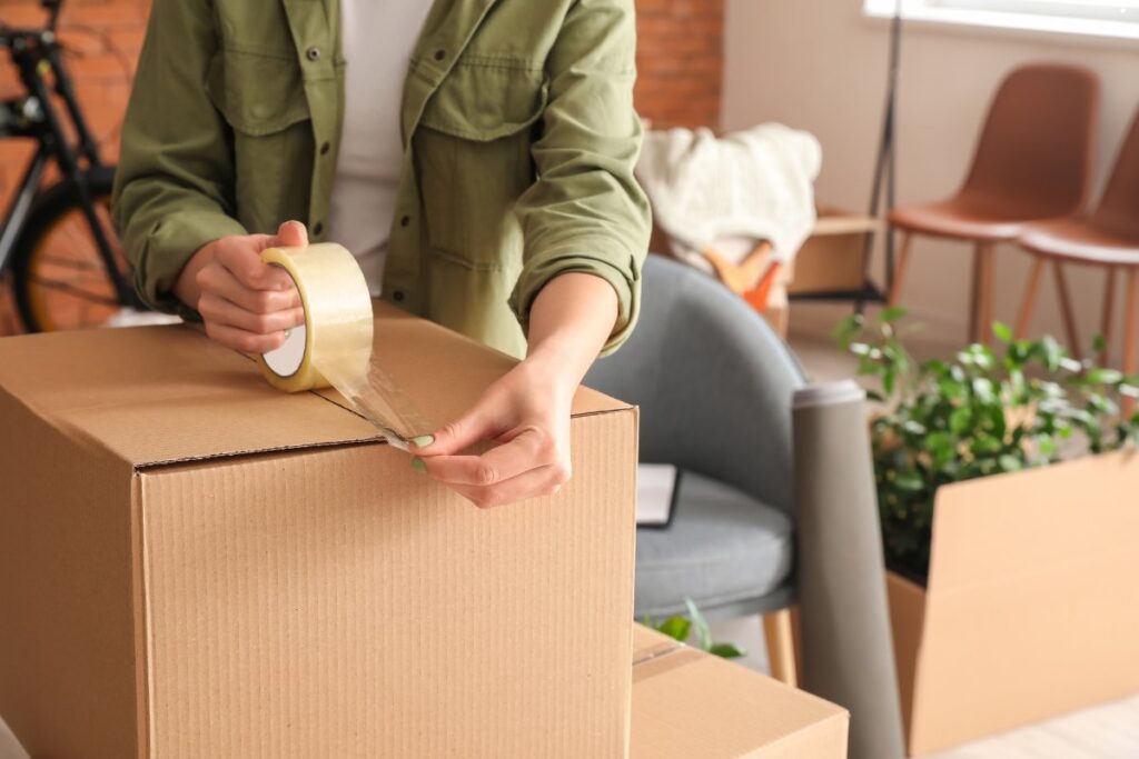 office worker sealing a box in preparation for a Long Island office move