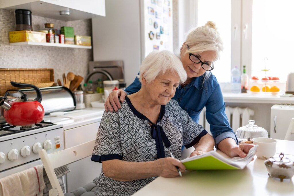 daughter and elderly mother reviewing moving tips