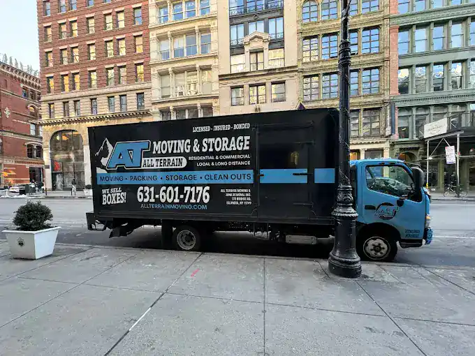 All Terrain Moving truck parked on city street for commercial moving services.