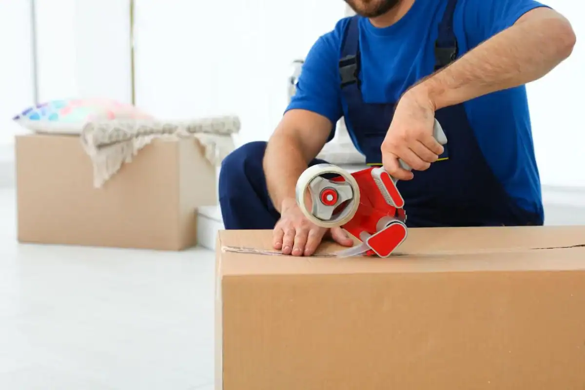 Professional packing with tape dispenser for moving and junk removal.